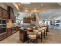 Gourmet kitchen with a large island, counter seating, and stainless steel appliances at 14332 E Bobwhite Way, Scottsdale, AZ 85262