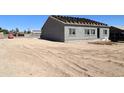 New construction of a single story home with a backyard undergoing landscaping at 15128 S Country Club Dr, Arizona City, AZ 85123
