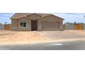 Charming single-story home with a brick driveway, stucco exterior, and a two-car garage at 15128 S Country Club Dr, Arizona City, AZ 85123