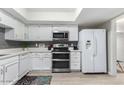 Contemporary kitchen with stainless steel appliances, white cabinets, and a neutral color scheme at 15610 N 29Th St # 3, Phoenix, AZ 85032