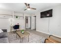 Comfortable living room featuring a large television, built-in shelving and neutral decor at 15610 N 29Th St # 3, Phoenix, AZ 85032