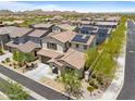 Expansive aerial view of the neighborhood showcasing the property with solar panels and lush desert landscaping at 17721 W Cassia Way, Goodyear, AZ 85338