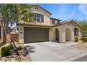 Beautiful home features a two-car garage, desert landscaping and an arched entryway, perfect for modern living at 17721 W Cassia Way, Goodyear, AZ 85338