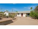Single-story home with mature landscaping and a circular driveway at 1845 N 64Th St, Scottsdale, AZ 85257