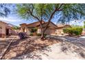 Attractive single-story home with lush landscaping and a wide driveway, perfect for families at 2556 W Amber Sun Dr, Phoenix, AZ 85085