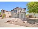 View of a stucco home with landscaping and a tile roof at 25726 W Burgess Ln, Buckeye, AZ 85326