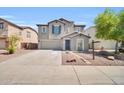 View of the front exterior of the home showing the two car garage at 25726 W Burgess Ln, Buckeye, AZ 85326