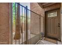 Condo's entry door behind a secure, stylish metal gate for added privacy and security at 2625 E Indian School Rd # 143, Phoenix, AZ 85016