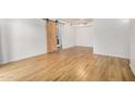 Spacious living room with a sliding barn door at 2625 E Indian School Rd # 143, Phoenix, AZ 85016