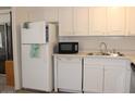 Well-lit kitchen features ample white cabinetry and stainless steel sink at 303 S Recker Rd # 78, Mesa, AZ 85206