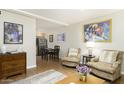 Spacious living room with hardwood floors, comfortable seating, and an adjacent dining area at 310 W Earll Dr # 102, Phoenix, AZ 85013