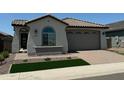 Charming single-story home with a tile roof, manicured lawn, and a brick-paved driveway leading to a two-car garage at 3375 W Verde River Rd, San Tan Valley, AZ 85144