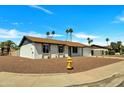 Inviting one-story home with low maintenance desert landscaping and a charming yellow fire hydrant at 3614 W Danbury Dr, Glendale, AZ 85308