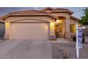 Close-up of the front exterior highlighting the home's two-car garage and decorative security door at 3713 W Nancy Ln, Phoenix, AZ 85041