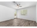 Bedroom with wood-look floors, bright natural light and access to the backyard at 40066 W Jenna Ln, Maricopa, AZ 85138