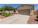 Well-maintained single-story home with desert landscaping, a two-car garage and a welcoming entrance at 40066 W Jenna Ln, Maricopa, AZ 85138