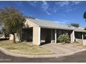 View of a well-maintained home showcasing desert landscaping, covered parking, and a clear, sunny sky at 4042 E Carson Rd, Phoenix, AZ 85042