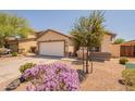 Lovely single-story home featuring a well-manicured lawn and two-car garage at 41767 W Somerset Dr, Maricopa, AZ 85138