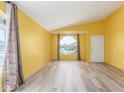 Bright living room with wood floors, yellow walls, and a large window at 4307 E Shetland Dr, San Tan Valley, AZ 85140