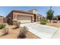Single-story home featuring a two-car garage, desert landscaping, and a covered porch at 5039 S 237Th Ln, Buckeye, AZ 85326