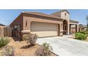 Single-story home featuring a two-car garage, desert landscaping, and a covered porch at 5039 S 237Th Ln, Buckeye, AZ 85326