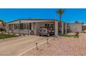 Inviting single-story home with covered parking, landscaped yard, and desert surroundings at 506 S 81St Pl, Mesa, AZ 85208