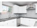 Close up on the kitchen featuring white cabinetry, stainless steel appliances, gray countertops, and subway tile backsplash at 540 Leisure World --, Mesa, AZ 85206
