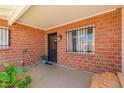 Welcoming covered front entrance with brick walls, wrought iron window guards, and a potted plant at 6541 N 41St Ave, Phoenix, AZ 85019