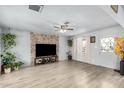 Bright and airy living room with light wood floors, a stone accent wall, and abundant natural light at 6541 N 41St Ave, Phoenix, AZ 85019