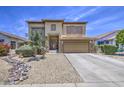Home exterior features a two-car garage, neutral paint, stone accents, gravel landscaping, and a paved driveway at 742 W Agrarian Hills Dr, San Tan Valley, AZ 85143