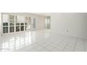 Bright living room with white tile flooring and plantation shutters offers a clean, modern aesthetic at 7740 E Heatherbrae Ave # 3, Scottsdale, AZ 85251