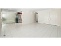 Open-concept living space featuring neutral walls, tiled floors, and modern stainless steel refrigerator at 7740 E Heatherbrae Ave # 3, Scottsdale, AZ 85251