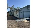 Exterior shot of home and garage, blue paint scheme, xeriscaping and window view at 8155 W Desert Cove Ave, Peoria, AZ 85345