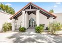 Arched entryway leading to the home's front door with desert landscaping at 8361 E San Rafael Dr, Scottsdale, AZ 85258