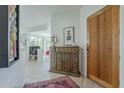 Bright foyer with a wooden door, stylish console table, and seamless access to the living area at 10222 E Southwind Ln # 1018, Scottsdale, AZ 85262