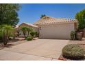 Beige single-story home with a two car garage and desert landscaping at 10845 W Manzanita Dr, Peoria, AZ 85345