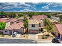 A high aerial shot of a two-story home featuring a red tile roof, desert landscaping, and a two-car garage at 1090 S Bogle Ct, Chandler, AZ 85286