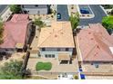 Aerial view showcases a backyard with artificial turf, a covered patio, and surrounding block fencing at 1090 S Bogle Ct, Chandler, AZ 85286