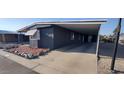 The manufactured home features ample parking under an attached carport at 11000 N 91St Ave # 84, Peoria, AZ 85345
