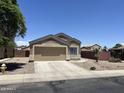 Charming single-Gathering home with two-car garage, desert landscaping, and paved driveway at 13004 W Saint Moritz Ln, El Mirage, AZ 85335