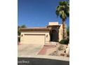 Inviting single-Gathering home boasts a well-manicured lawn, desert landscaping, and a two-car garage at 1502 E Estrid Ave, Phoenix, AZ 85022