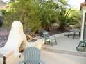 Relaxing patio features comfortable seating, lush trees, and a charming fireplace for outdoor enjoyment at 1502 E Estrid Ave, Phoenix, AZ 85022