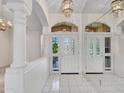 Bright entryway featuring decorative doors, tiled floors, and architectural columns at 15377 W Catalina Ct, Goodyear, AZ 85395