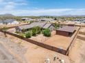 Aerial view of a sprawling property with an extended storage shed and fenced-in desert landscaping at 15438 E Milton Dr, Scottsdale, AZ 85262