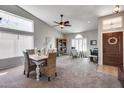 Bright dining area with vaulted ceilings featuring a dining table and adjacent office setup at 16250 S 13Th St, Phoenix, AZ 85048