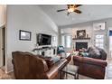 Cozy living room with high ceilings, a fireplace, and comfortable leather furniture at 16250 S 13Th St, Phoenix, AZ 85048