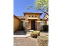 Charming front entrance featuring stone accents, covered entryway, and well-maintained landscaping at 16559 W Lincoln St, Goodyear, AZ 85338