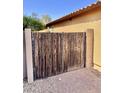 Rustic wooden gate providing privacy and security for this well-maintained residence at 16559 W Lincoln St, Goodyear, AZ 85338
