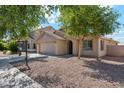 Attractive single-level home featuring desert landscaping, an attached two-car garage, and covered entry at 1718 E Harwell Rd, Phoenix, AZ 85042
