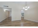Bright living room featuring wood flooring and a stylish chandelier at 17441 N Del Webb Blvd, Sun City, AZ 85373